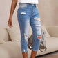 Damen-Jeans mit Used-Optik, Rissen und rohem Saum
